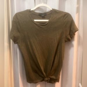 Army green colored tee shirt (short sleeves). Knotted at the bottom.